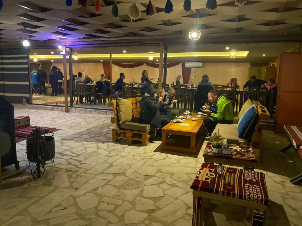 Guests relaxing in the camp's lobby and dining area in the evening