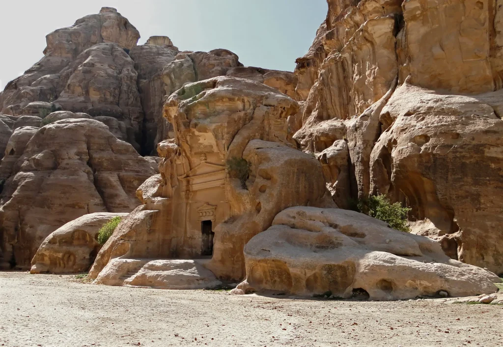 Rock-cut chambers in the sandstone walls of Little Petra