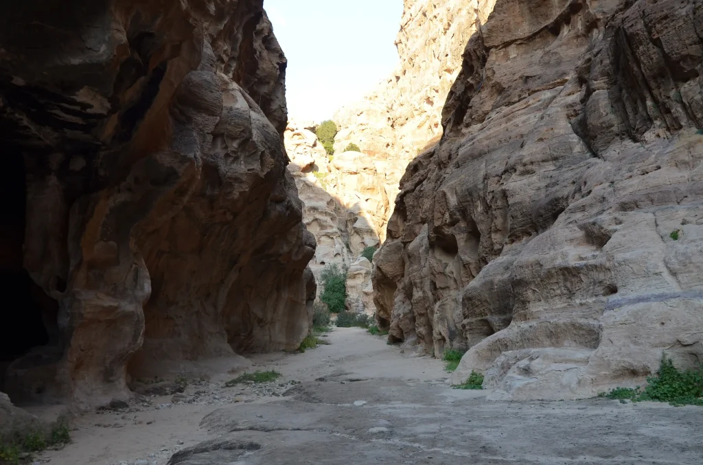 Carved Nabataean facade among sandstone boulders at Little Petra (Siq al-Barid)